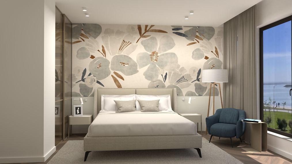 Bedroom with an oversized floral wallpaper and a blue armchair